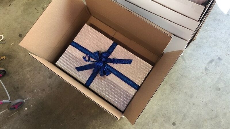 Fully-assembled present ready to ship to cast members around the world to give the illusion of a single present being virtually passed around.