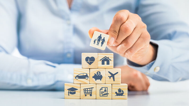 Person building a collection of blocks
