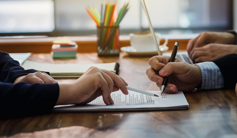 People working together on signing a contract