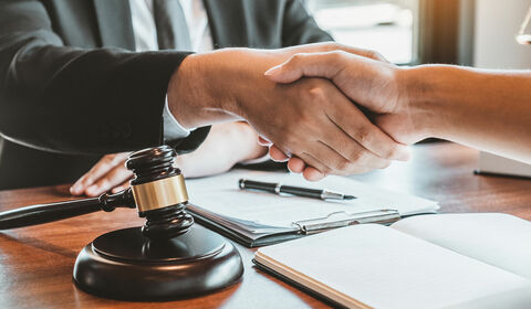 Attorney shaking hands with client
