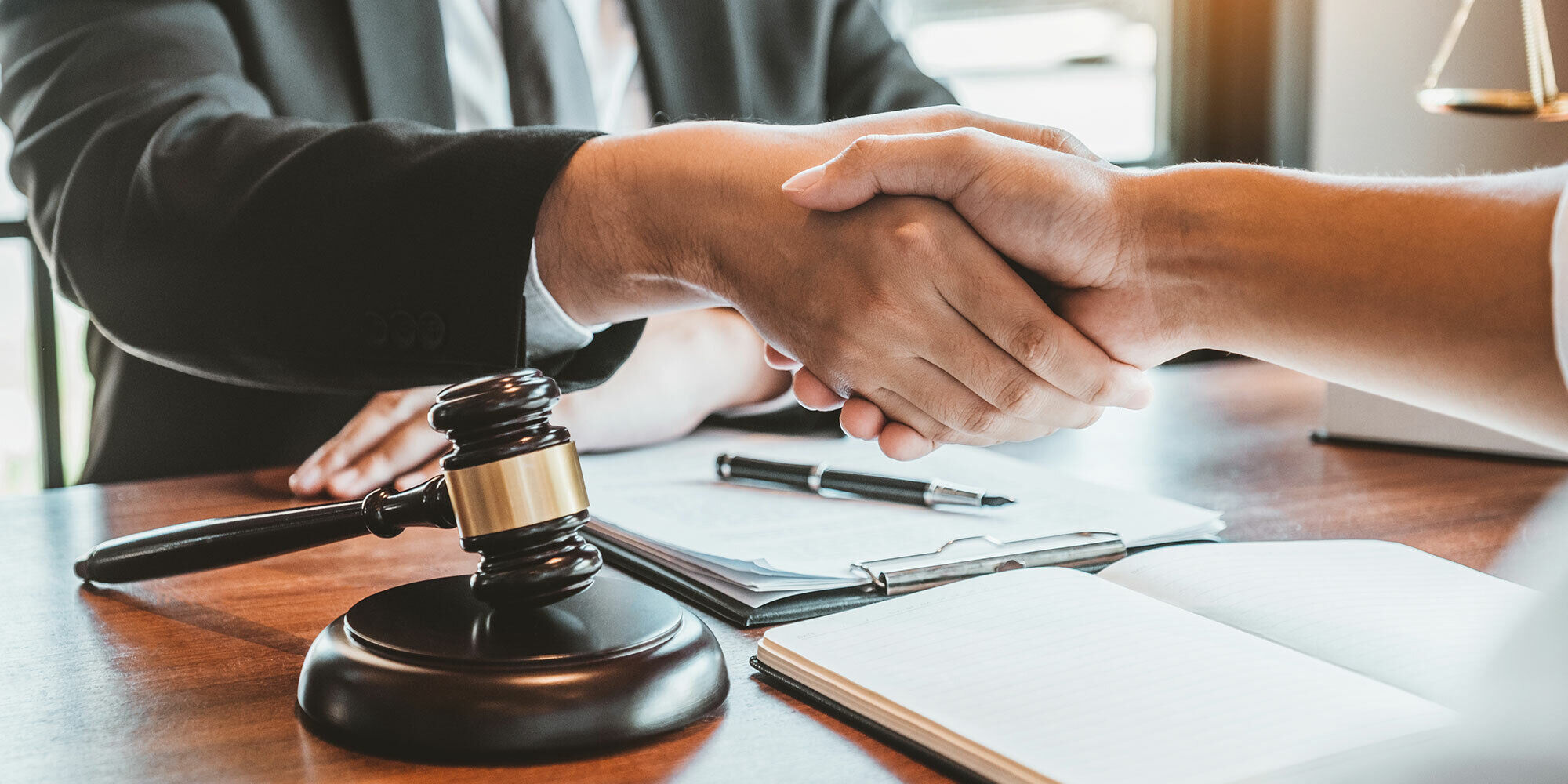 Attorney shaking hands with client