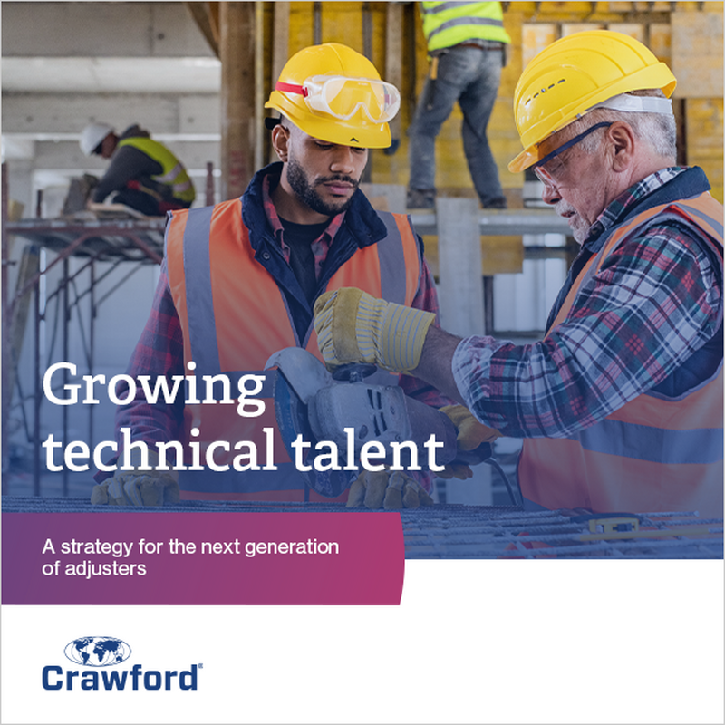 Construction workers in safety gear working on a building site