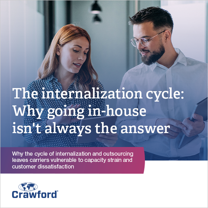 Two people walking in an office hallway