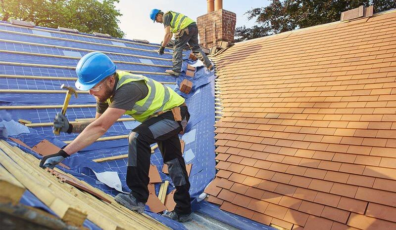 Roofing contractors installing a roof