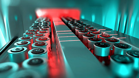 Batteries on a conveyor built in a manufacturing facility